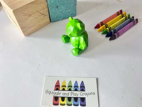 A geometric 3D crayon shaped like a sitting teddy bear