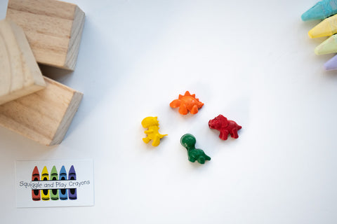 Small crayons shaped as stegosaurs, triceratops, t-rex and brachiosaurs