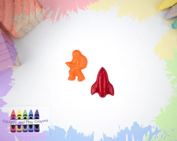 an orange cartoon astronaut crayon with a red rocketship crayon