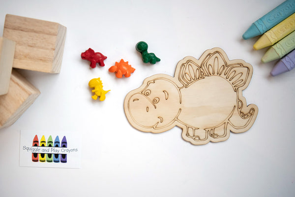 4 small cartoon dinosaur crayons with a large wooden laser-engraved cartoon stegosaurus 