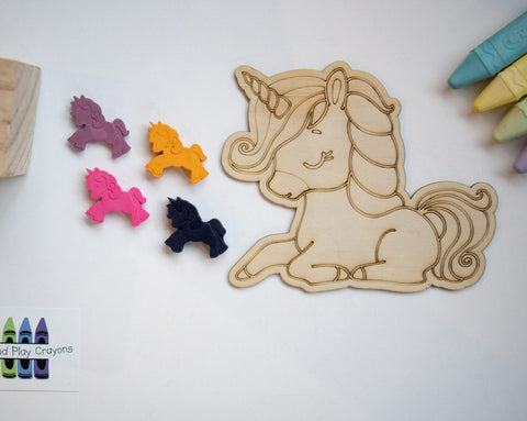 4 small leaping unicorn crayons with a large wooden laser-engraved cartoon lying unicorn