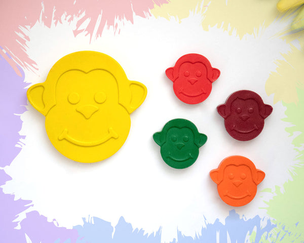 A large, yellow crayon in the shape of a 2D smiling money face, with 4 smaller versions