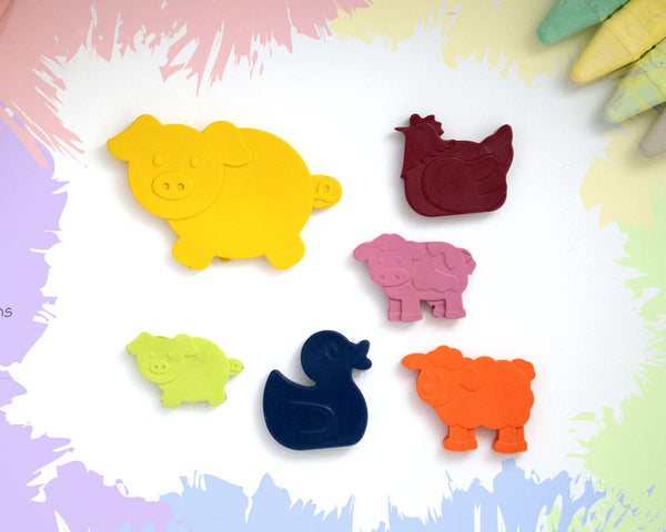 A large, yellow pig crayon with 5 smaller crayons, a duck, a chicken, a pig, a sheep, and a cow