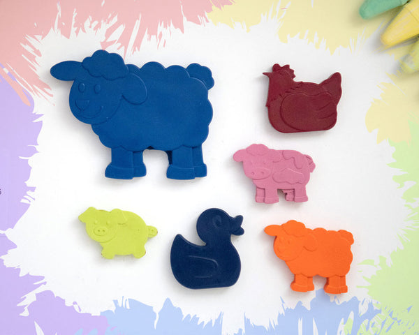 A large, dark blue cow crayon with 5 smaller crayons, a duck, a chicken, a pig, a sheep, and a cow