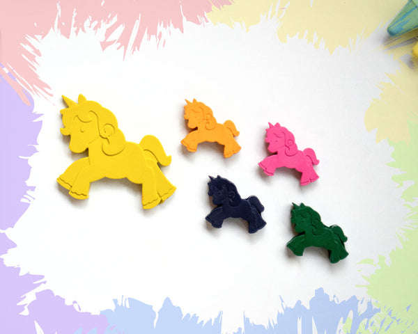 A large, yellow crayon in the shape of a leaping unicorn, with 4 smaller versions